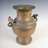 A Chinese bronze twin handled vase, Qing Dynasty, with archaic line decoration, the handles formed