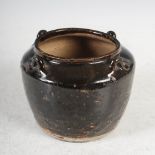A Chinese brown glazed pot, the shoulder set with four raised loops, 10cm diameter x 11.5cm high.