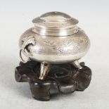 A Chinese silver koro and cover, Qing Dynasty, decorated with scrolls, the shell cast terminals