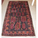 An Afghan War rug, the chocolate coloured ground decorated with three rows of mirhab shaped