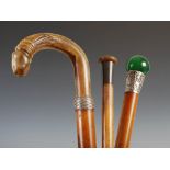 Two Chinese malacca walking canes, to include; a green glass and white metal mounted cane, 93.5cm