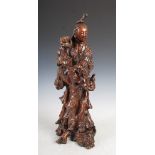 A Chinese root wood figure of a goddess, Qing Dynasty, on carved root wood plinth, 61cm high.