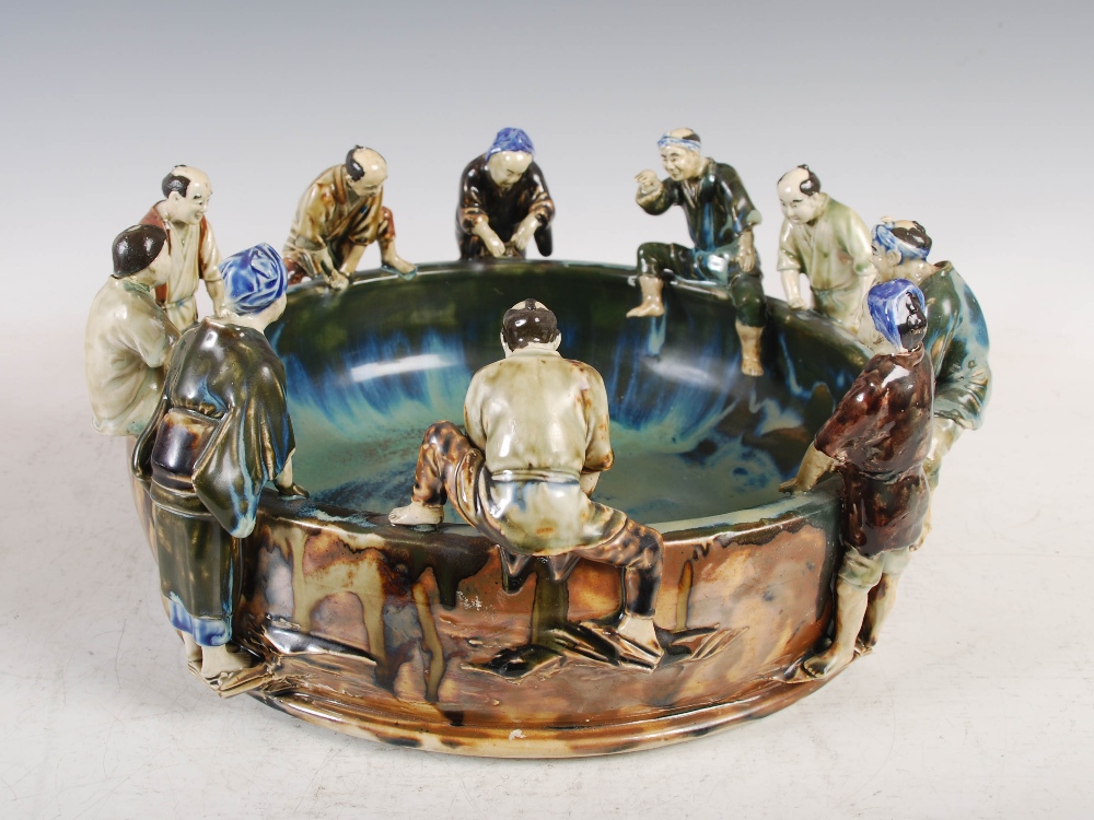 A Japanese ceramic fish bowl, early 20th century, modelled with ten figures around the rim,