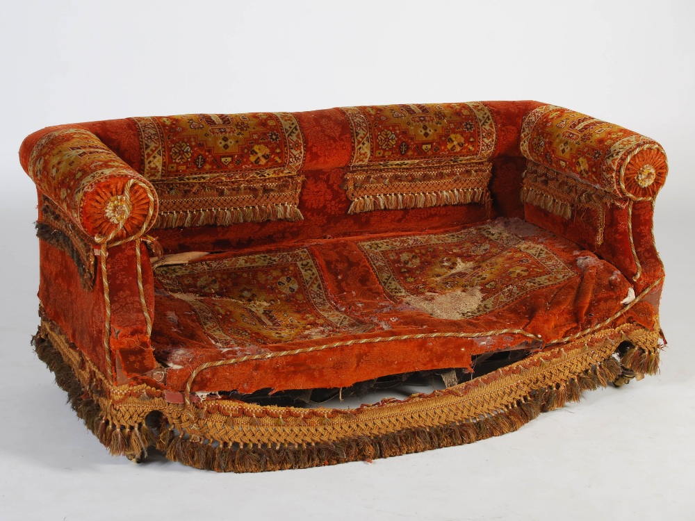 A Victorian mahogany carpet upholstered two seat sofa, raised on tapered cylindrical supports with