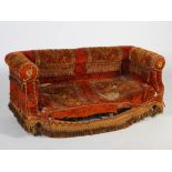 A Victorian mahogany carpet upholstered two seat sofa, raised on tapered cylindrical supports with
