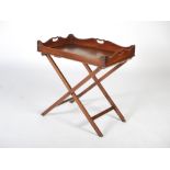 A 19th century mahogany butler's tray on stand, the rectangular tray with raised gallery edge
