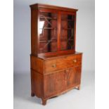 A 19th century mahogany and boxwood lined secretaire bookcase, the moulded cornice and dentil frieze