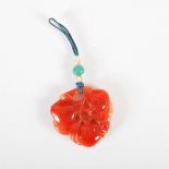 A Chinese carnelian three peach pendant, Qing Dynasty, carved and pierced with three peaches