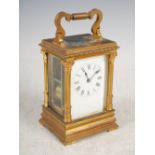 A late 19th/ early 20th century French gilt brass repeating carriage clock, the white enamel dial