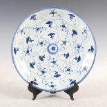 A Chinese porcelain blue and white dish, decorated with a petal design enclosing flowers and