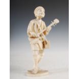 A Japanese ivory sectional okimono of a samisen player, Meiji Period, 22cm high.