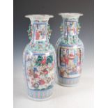 A large pair of Chinese porcelain famille rose Canton vases, Qing Dynasty, decorated with panels