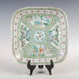 A Chinese porcelain famille rose square shaped dish, Qing Dynasty, decorated with panels of