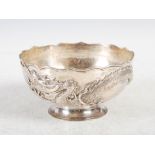 A Chinese silver footed bowl, Wang Hing, Qing Dynasty, decorated in relief with a dragon,