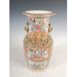 A Chinese porcelain famille rose Canton vase, Qing Dynasty, decorated with panels of figures,