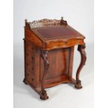 A Victorian walnut Davenport, the rectangular top with pierced scroll three quarter gallery, above a