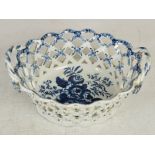 An 18th century Worcester blue and white porcelain twin handled basket, the interior decorated