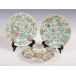 A pair of Chinese porcelain celadon ground famille rose plates, Qing Dynasty, decorated with