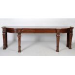 An impressive William IV mahogany serving table, the shaped rectangular top above two blind frieze
