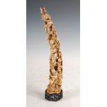 A Chinese ivory tusk carving, Qing Dynasty, carved with figures, pine tree and phoenix, on pierced