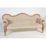 A Victorian mahogany sofa, the button down velvet upholstered back, arms and seat raised on