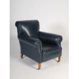 An early 20th century mahogany blue leather upholstered armchair, raised on tapered square