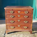 A George III mahogany bachelors chest, the rectangular top above a brush slide and four long