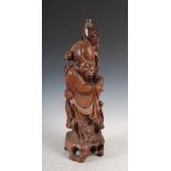 A Chinese carved wood figure Shou Lao, converted to a table lamp, with inlaid eyes and teeth,