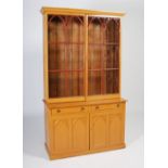 A 19th century painted pine Regency bookcase, the moulded cornice above a pair of Gothic astragal