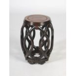 A Chinese dark wood and burr wood barrel shaped stool, late 19th/early 20th century, the panelled