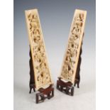 A pair of Chinese ivory wrist rests, Qing Dynasty, finely carved with pavilions, pine trees and