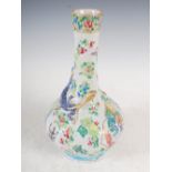 A Chinese porcelain famille rose bottle vase, Qing Dynasty, decorated panels of Court figures on a