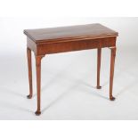 A George III mahogany card table with concertina action, the hinged rectangular top with a moulded