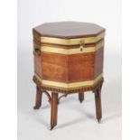 A 19th century mahogany and brass bound octagonal shaped wine cooler, the hinged cover opening to