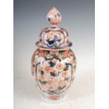 A Japanese Imari jar and cover, Meiji Period, the fluted body decorated with shaped rectangular