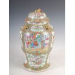 A Chinese porcelain famille rose Canton jar and cover, decorated with panels of figures, flowers and