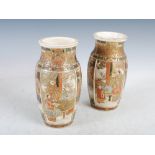 A pair of Japanese Satsuma pottery vases, Meiji Period, decorated with panels of figures divided