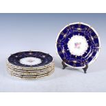 A set of eight Royal Crown Derby cobalt blue ground fruit plates, dated 1911, hand painted with