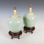 A pair of Chinese porcelain celadon ground jars on carved and pierced wood stands converted to table
