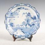 A Japanese porcelain blue and white dish, late 19th/early 20th century, decorated with river