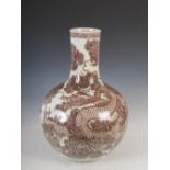 A large Chinese porcelain copper red decorated bottle vase, decorated with a dragon and scrolls,
