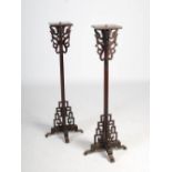 A pair of Chinese dark wood lantern stands, late 19th/ early 20th century, the square tops supported