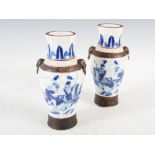 A pair of Chinese porcelain blue and white crackle glazed vases, Qing Dynasty, painted with