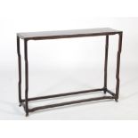 A Chinese dark wood console table of neat proportions, the rectangular panelled top raised on four