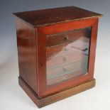 A Victorian mahogany table top specimen cabinet, the glazed cupboard door opening to a fitted