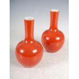 A pair of Chinese porcelain coral ground bottle vases, late Qing Dynasty, 20cm high.