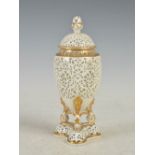 A Grainger & Co. Worcester reticulated porcelain urn and cover, with gilded details, printed