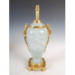 A late 19th/early 20th century ormolu mounted celadon ground pate-sur-pate urn and cover,