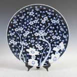 A Japanese blue and white porcelain charger, late 19th/early 20th century, decorated with rock