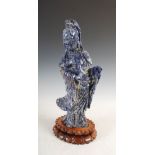 A Chinese lapis lazuli figure of Guanyin, carved standing holding ruyi scepter in her right hand,